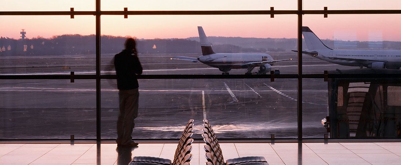 silhouetto of a man in an airport at dusk