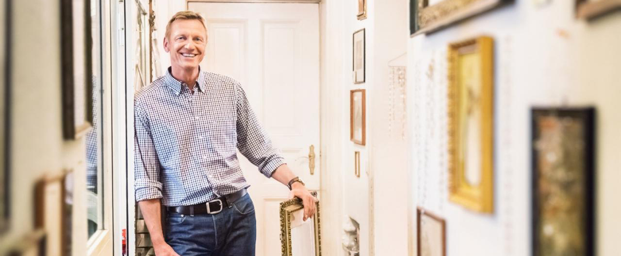 man smiling about valuable possessions