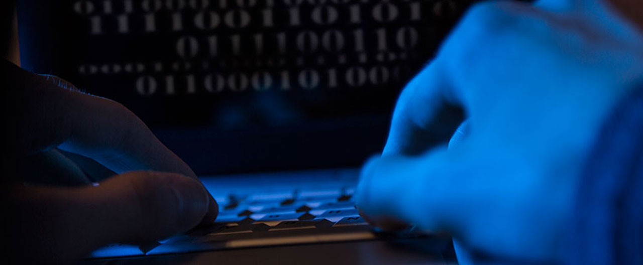 hand typing on laptop blue filter