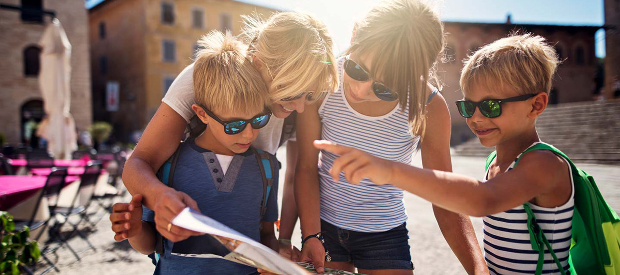 family checking map in italian town of massa marittima in tuscany