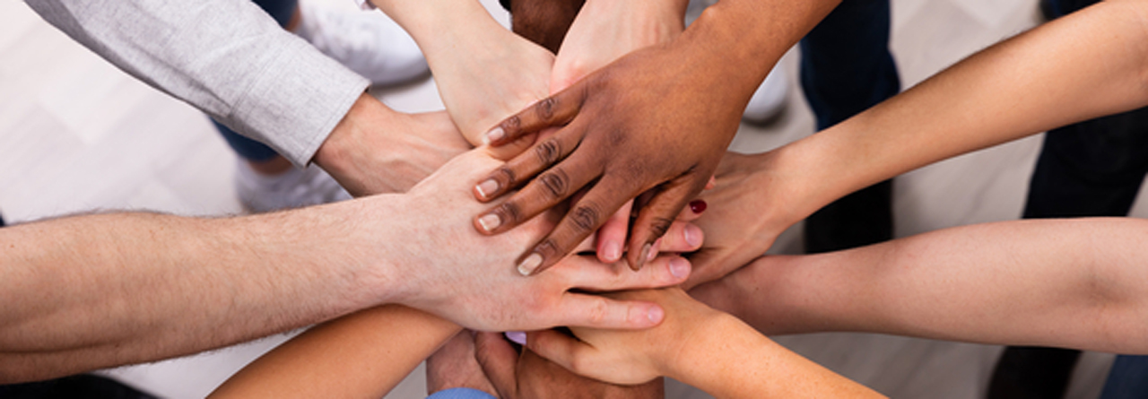 diverse peoples hands together