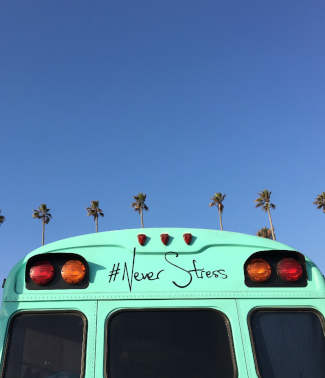 blue sky and a van with never stress written on it