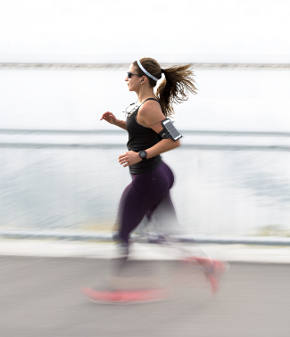 woman running with sunglasses and headband