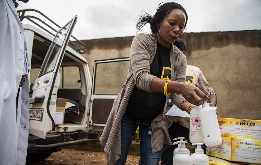 An IRC health care worker washes his hands outside a health facility in DRC.