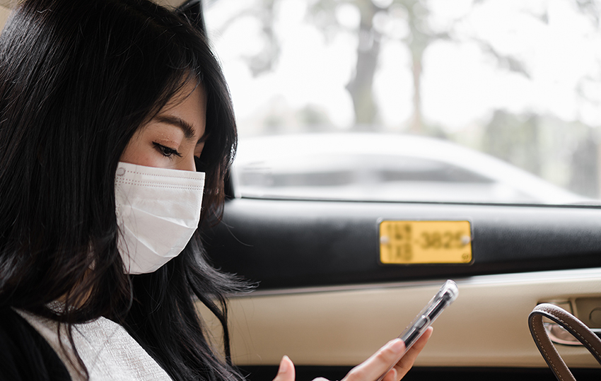woman wearing mask sitting in car 