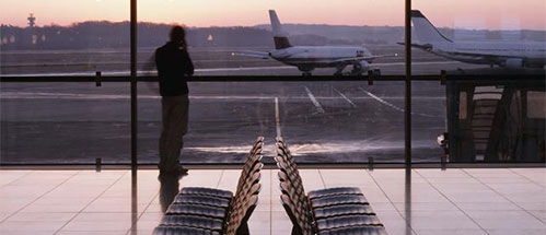 a person sitting on a tarmac at an airport