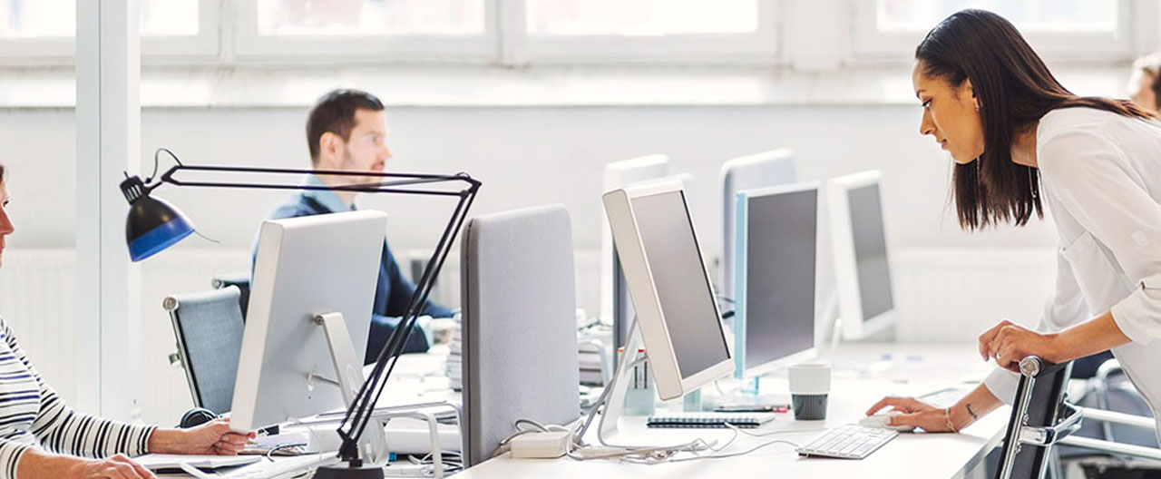 people in office with desktop