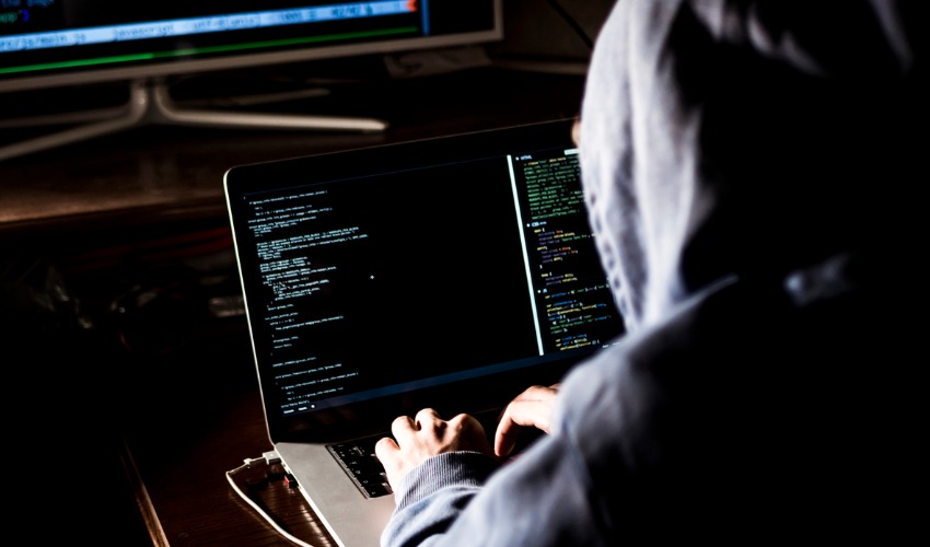 man with a hoodie writing code