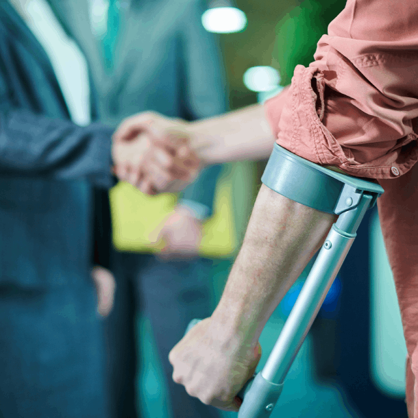 person with crutches shaking hands