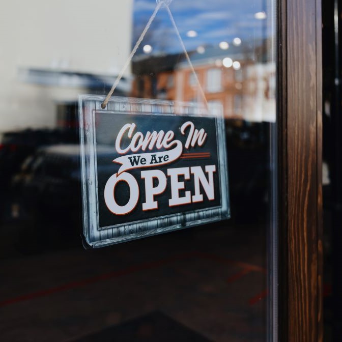 small lower midmarket business insurance open sign