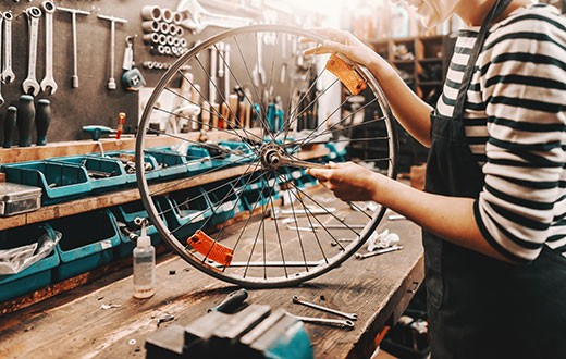 woman doing bike shop repair