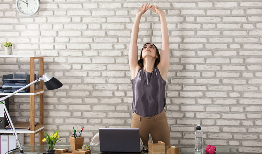 Woman stretching at desk