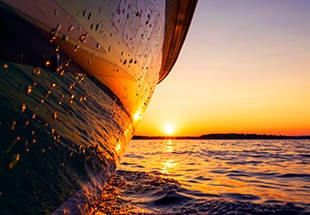 close up of boat in water during sunset
