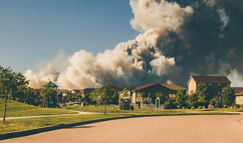 A wildfire coming close to a home