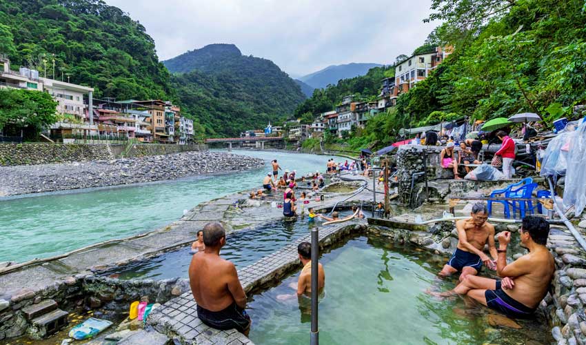visitors bathing in public hot springs baths in wulai village