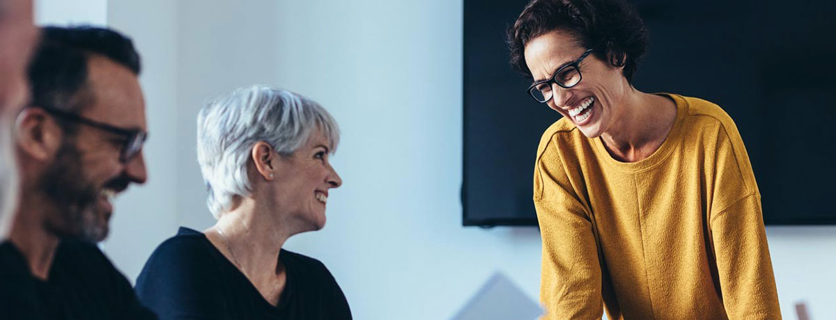 woman in yellow talking to the room