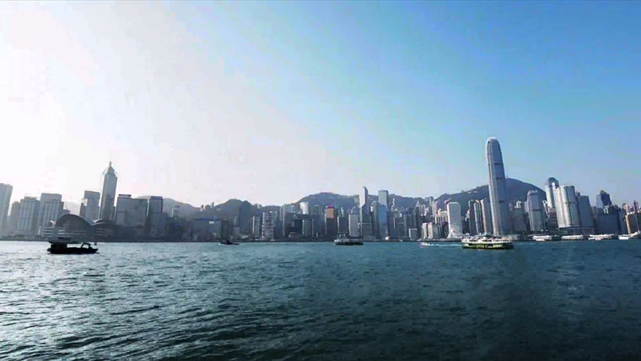 a large body of water with a city in the background