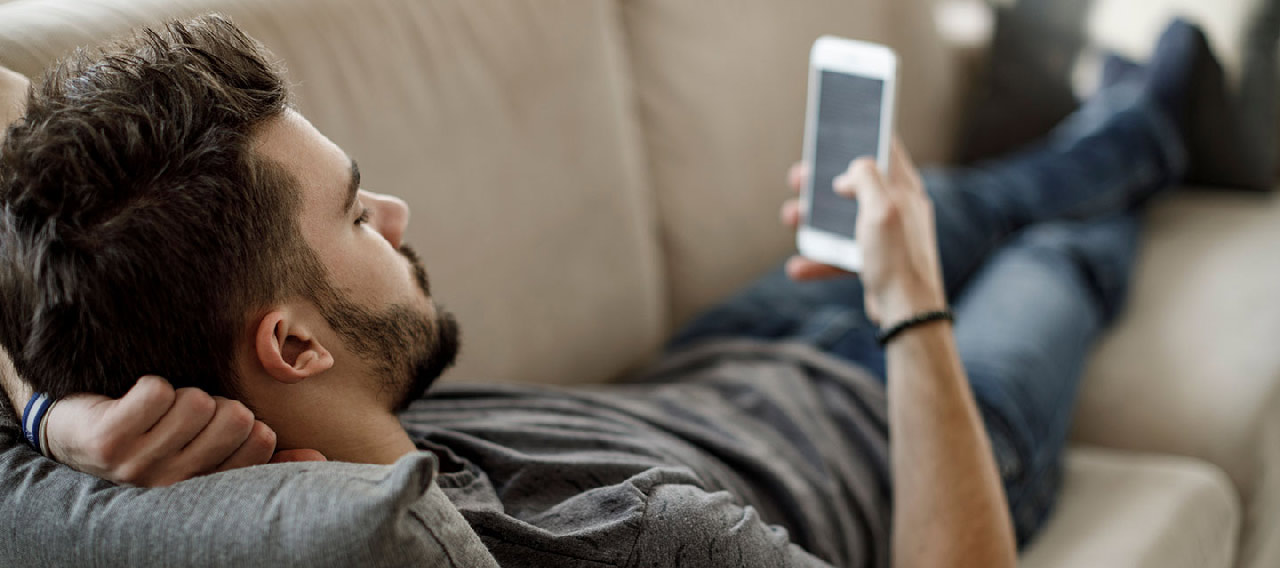 a guy lays on the couch