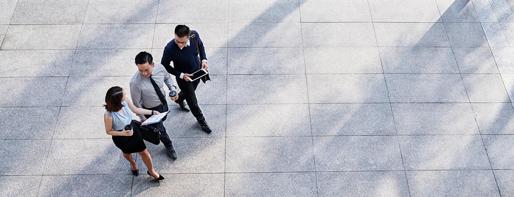 business woman leading meeting around conference table