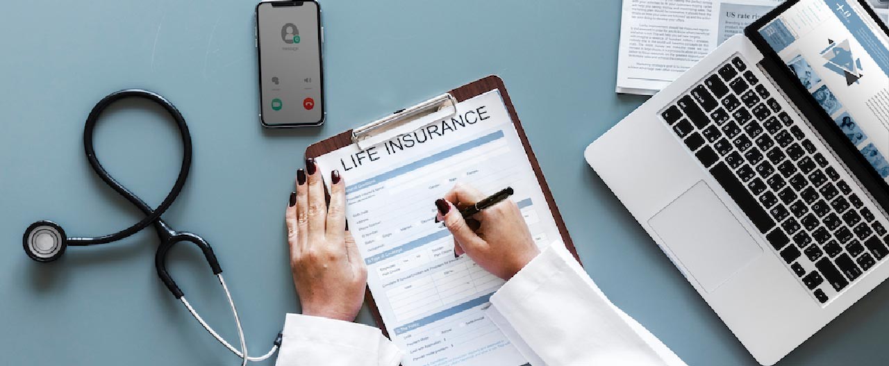 doctor filling life insurance form
