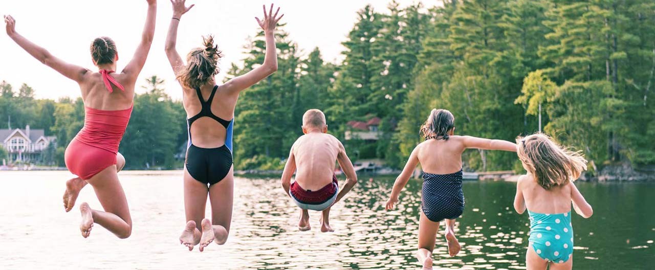family jumping into lake