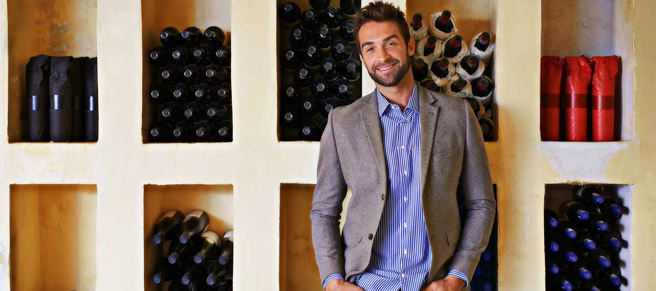 guy in front of wine collection