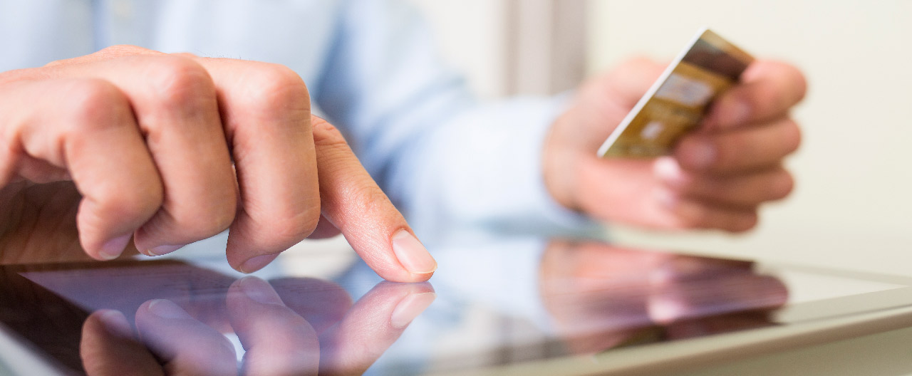 man using tablet and card
