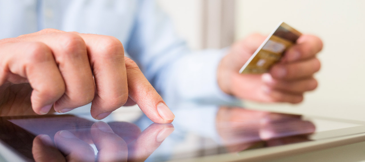 man using tablet and card