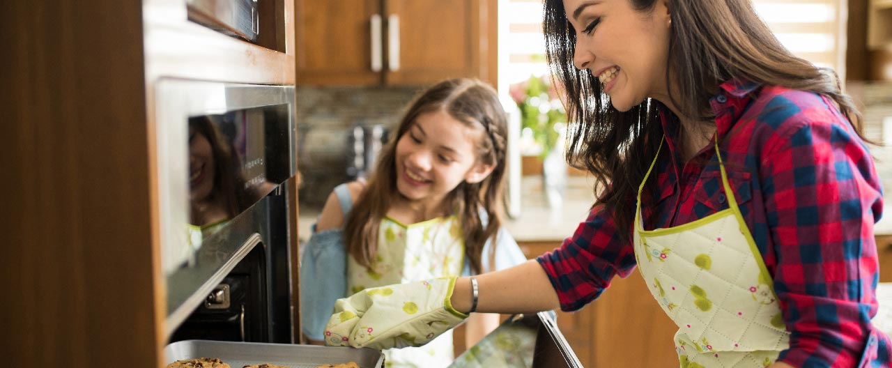 mom and daughter baking together