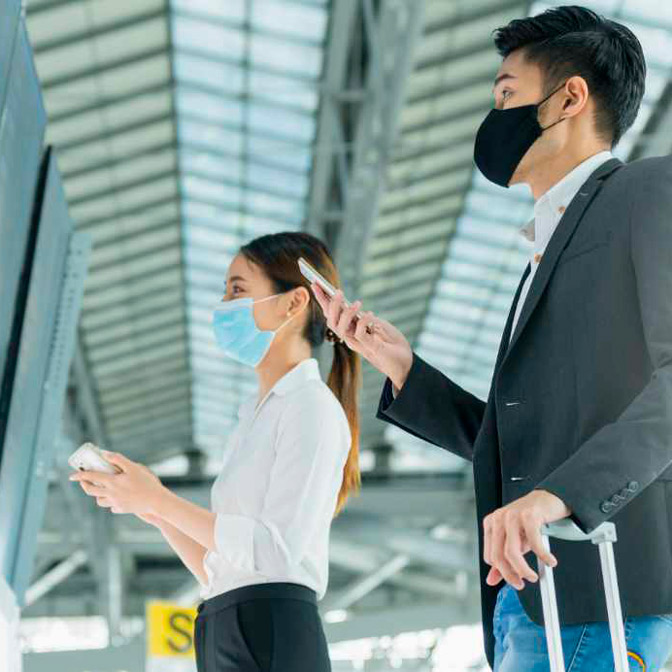 safe-travel-woman-man-looking-at-flight-schedule-board