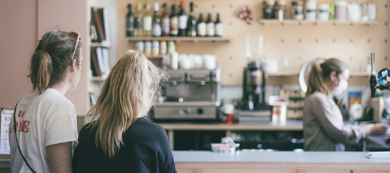 two people waiting for coffee in a store