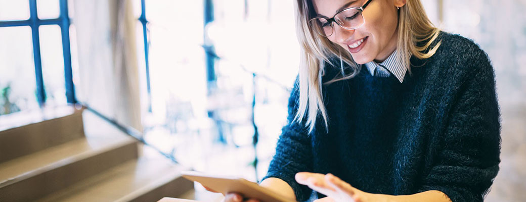 Portrait of young attractive woman using tablet