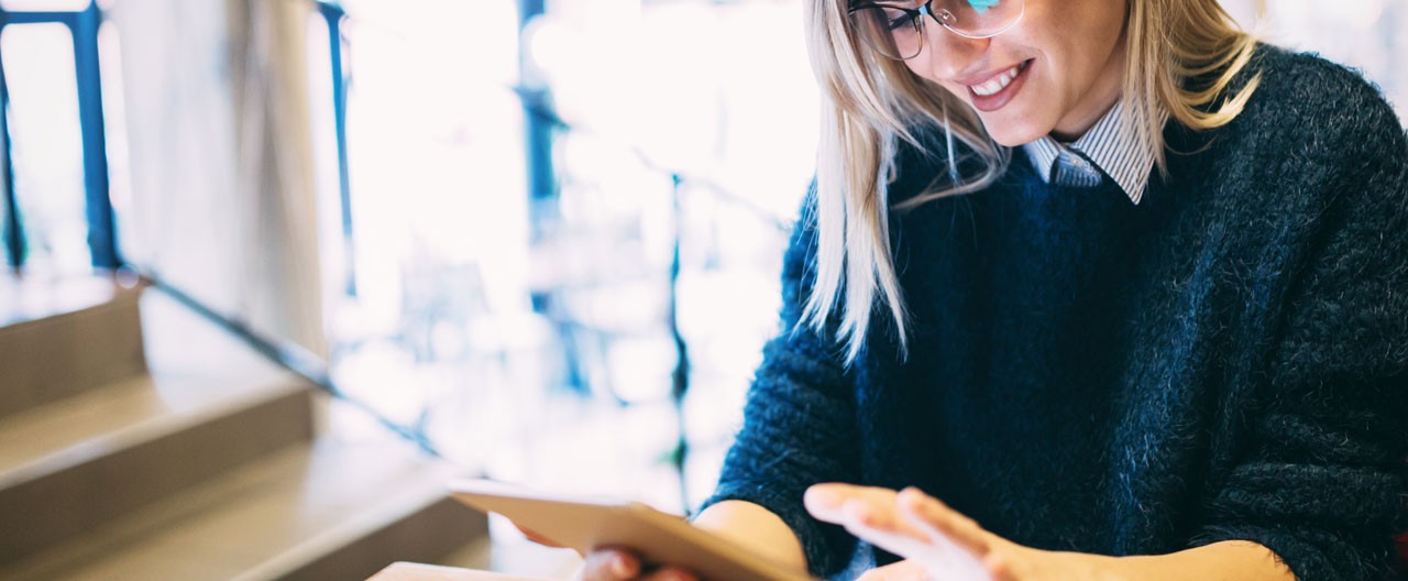 Portrait of young attractive woman using tablet