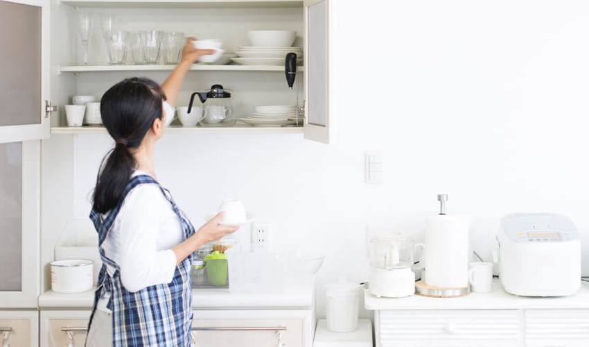 woman putting dishes away