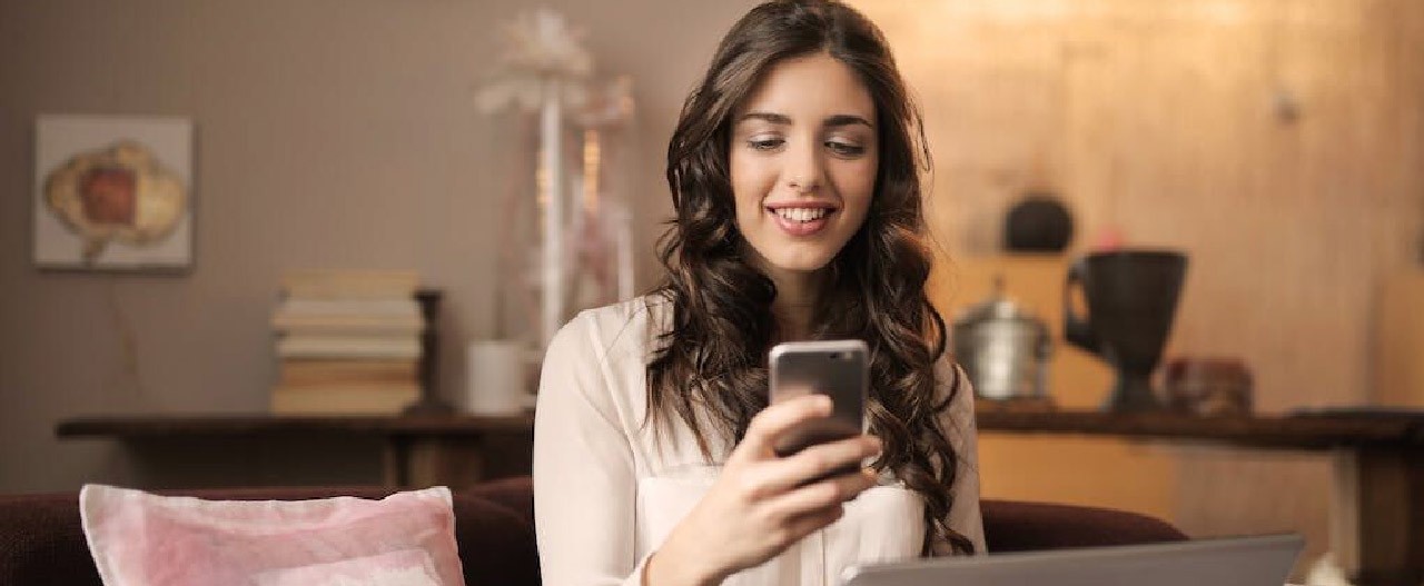 woman smile looking at phone