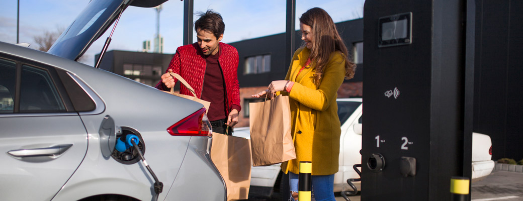 young couple charging EV