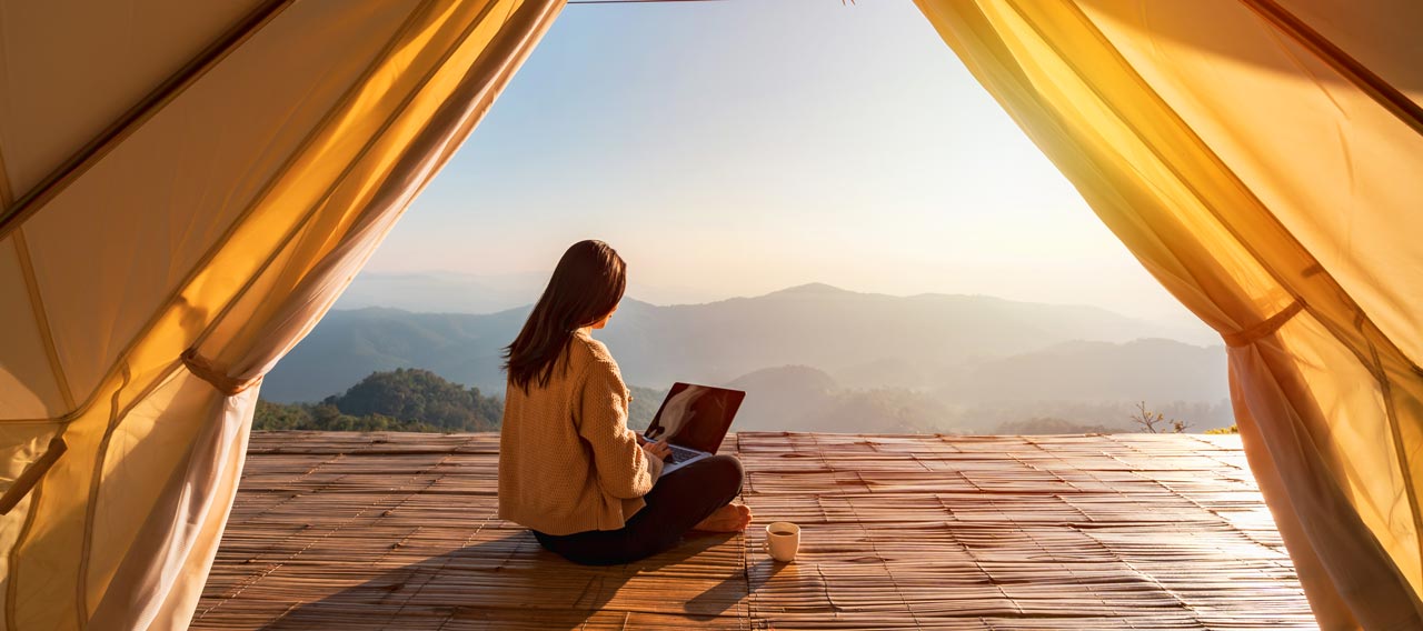 girl using laptop at tent