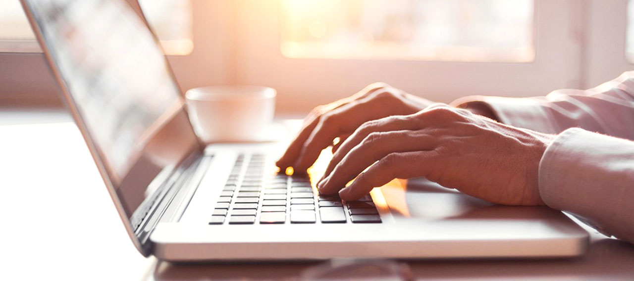 hand typing on laptop