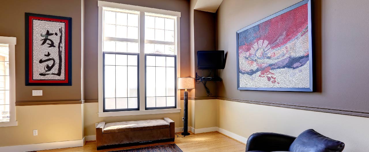 living room with windows and paintings