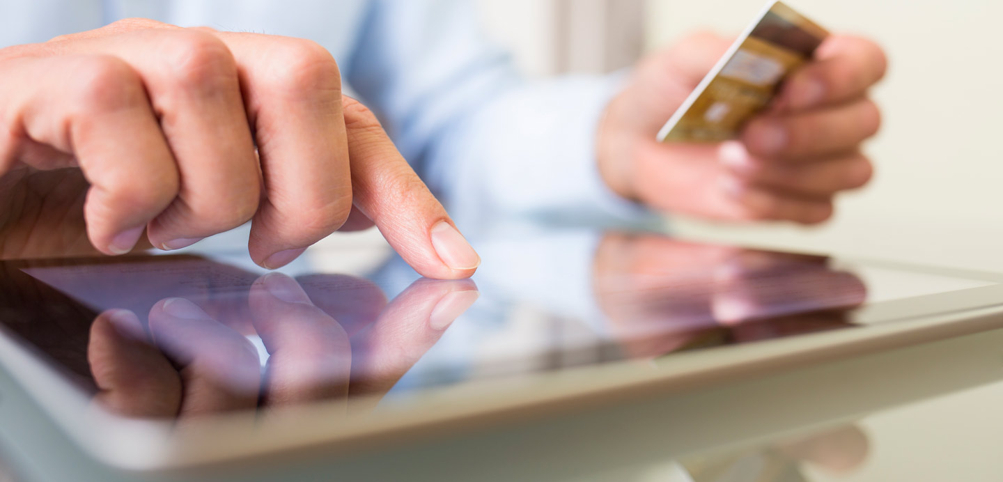 man-using-tablet-and-card