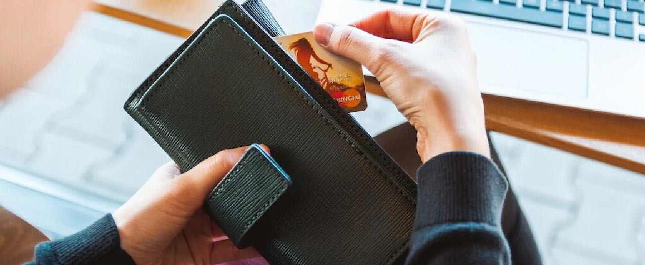 person pulling card from wallet