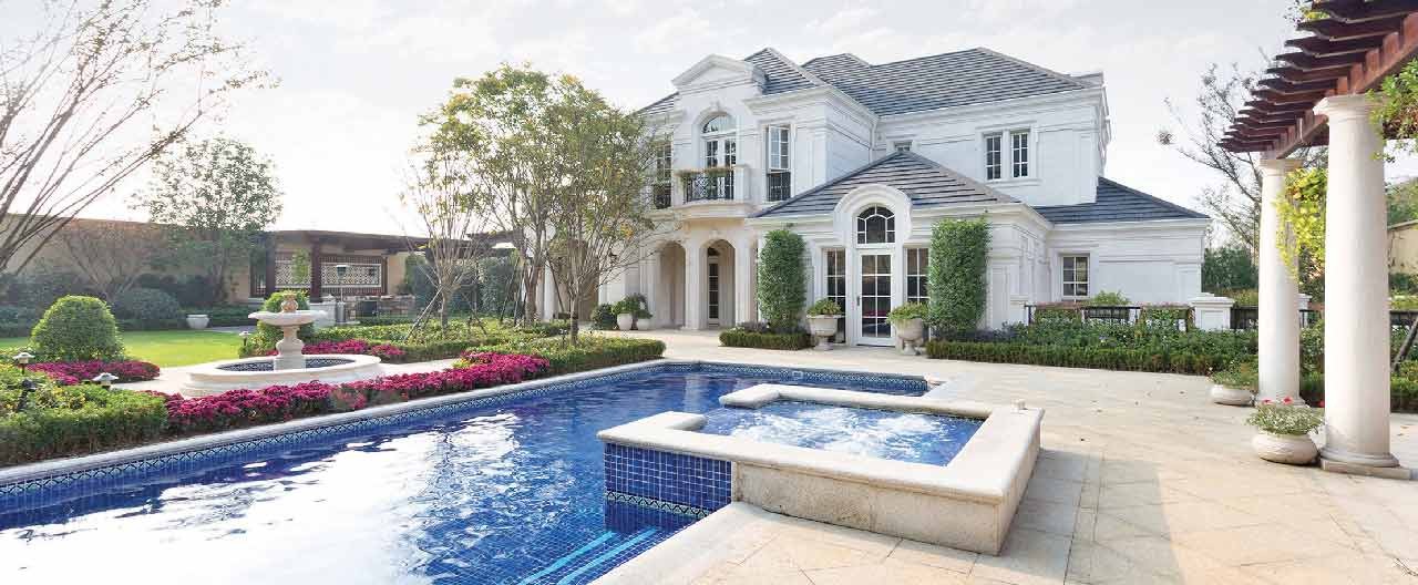 white house with front yard and pool