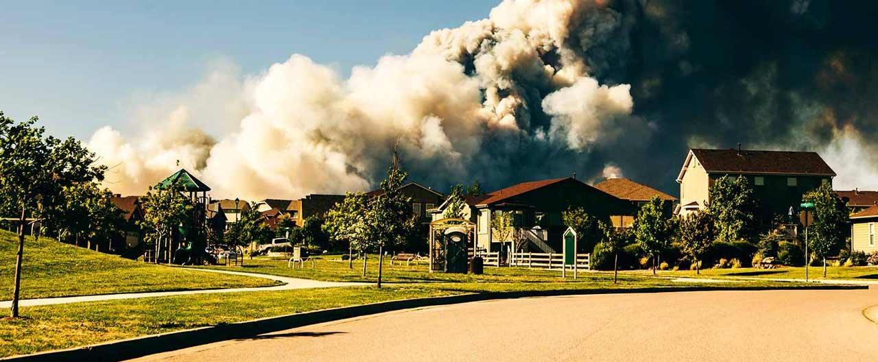 wildfire behind the houses