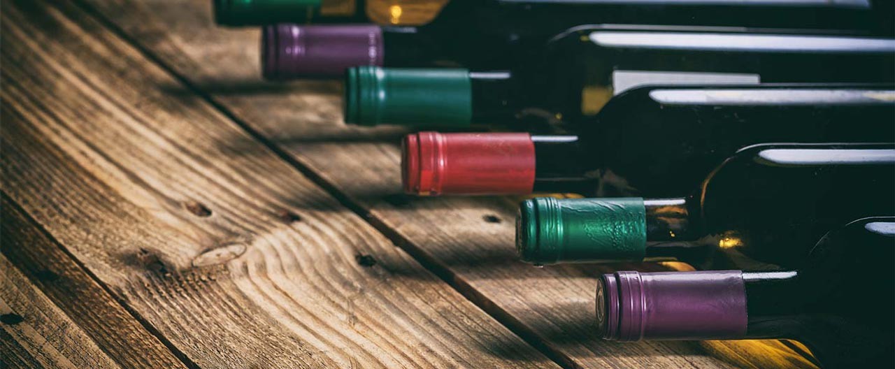 wine bottle collection on a wooden table